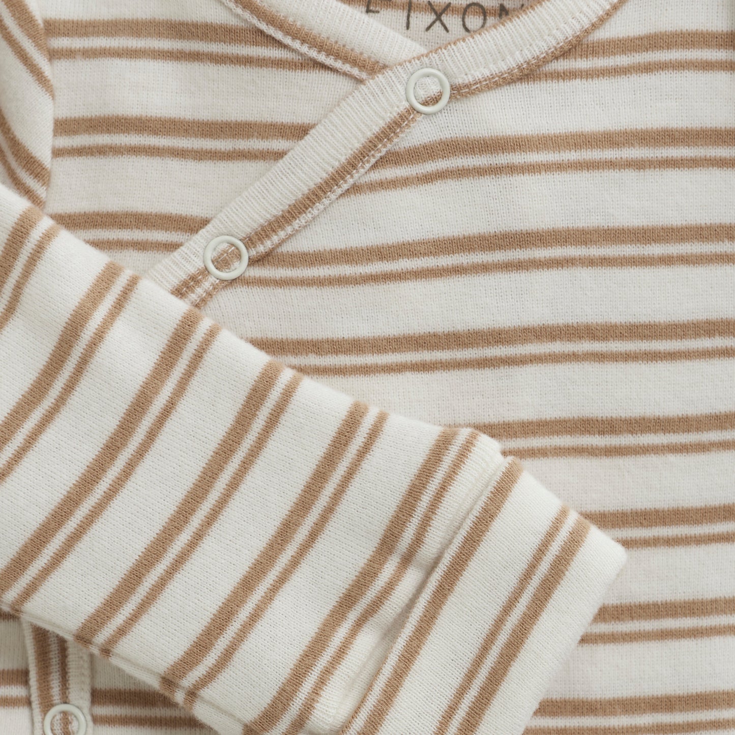 Close up product image of a long sleeve wrap front baby bodysuit