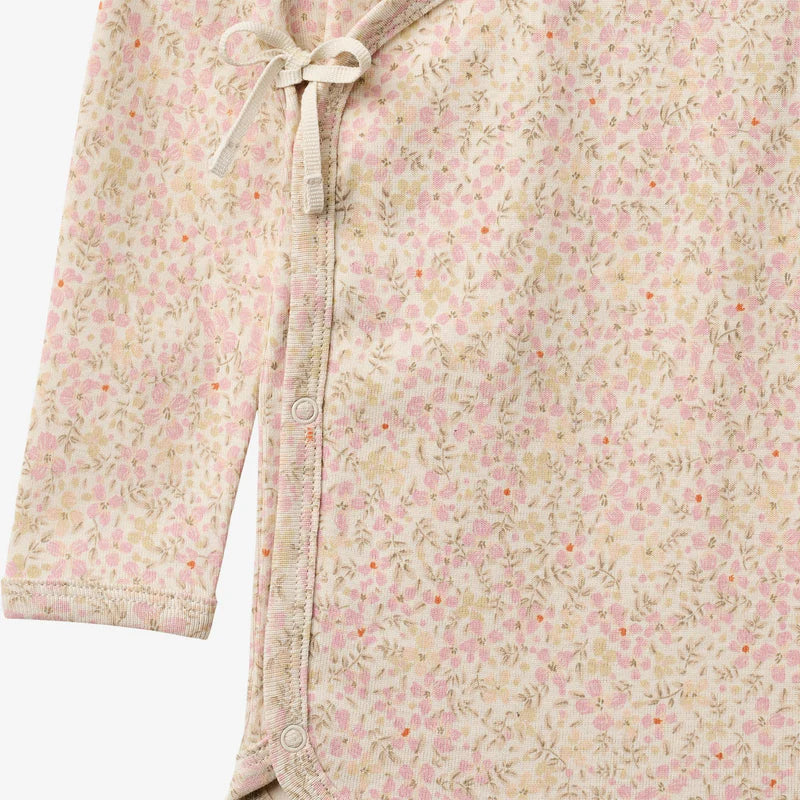 Close up product image of floral baby wrap bodysuit