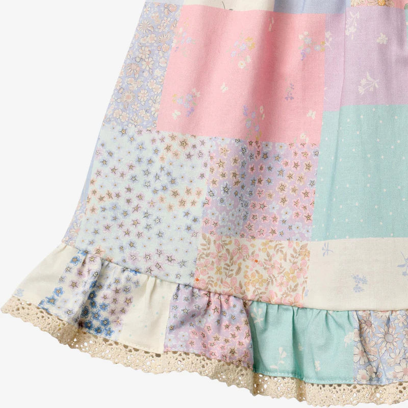 Close up product image of patchwork baby dress with ruffles
