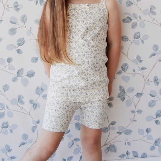 young girl standing in a matching tank top and bike shorts