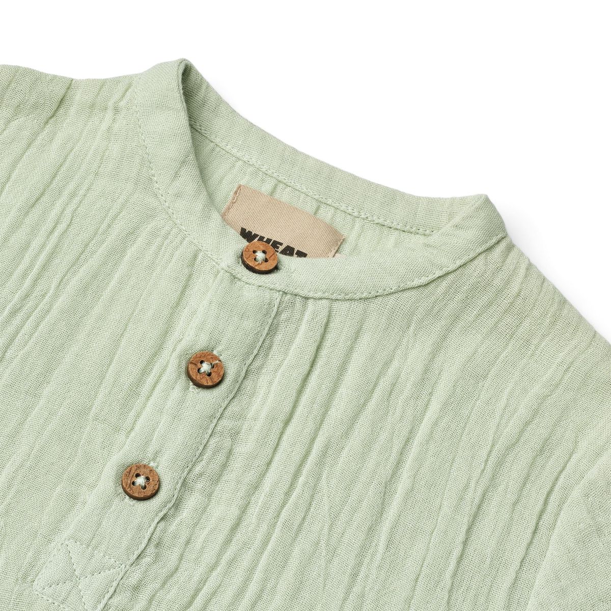 Close up product image of a woven relaxed fit baby shirt
