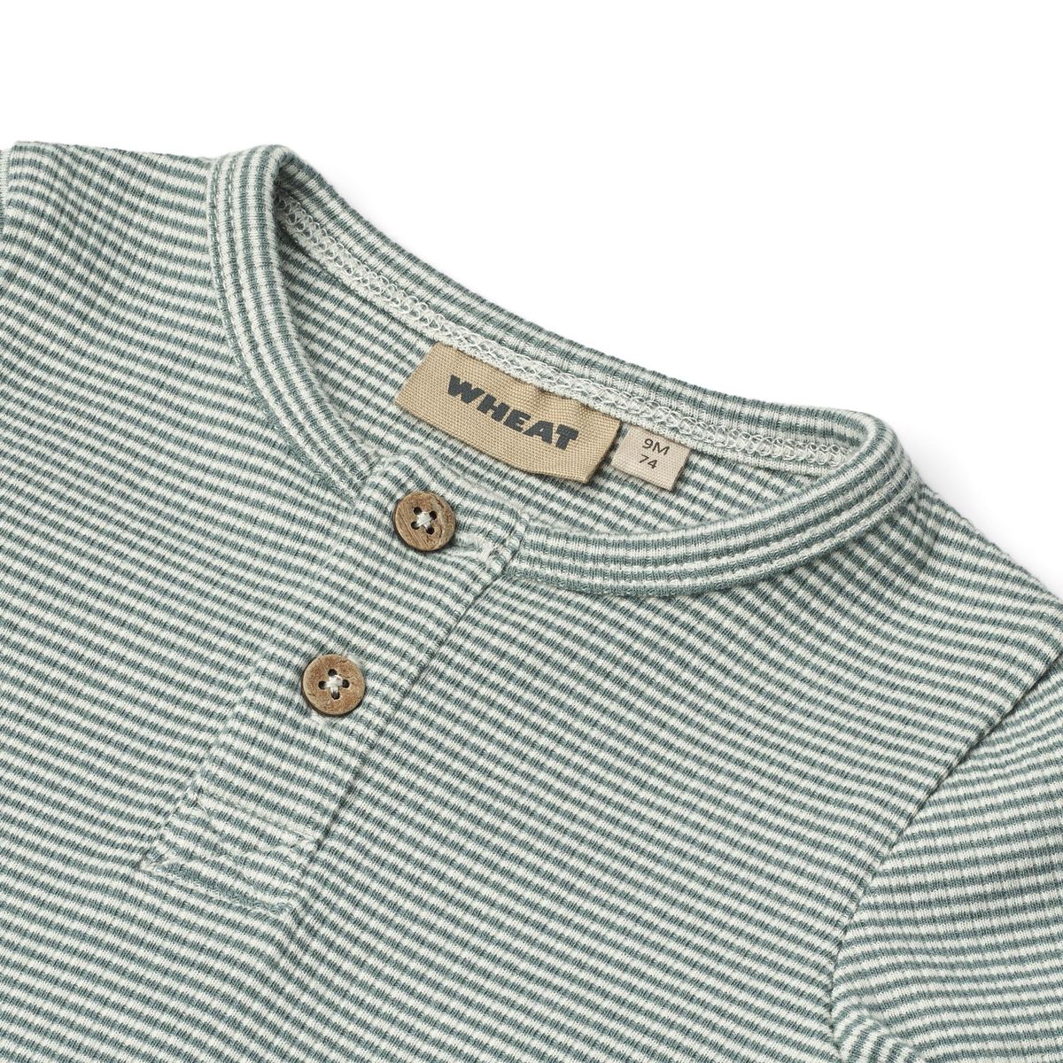 Close up product image of a long sleeve baby bodysuit