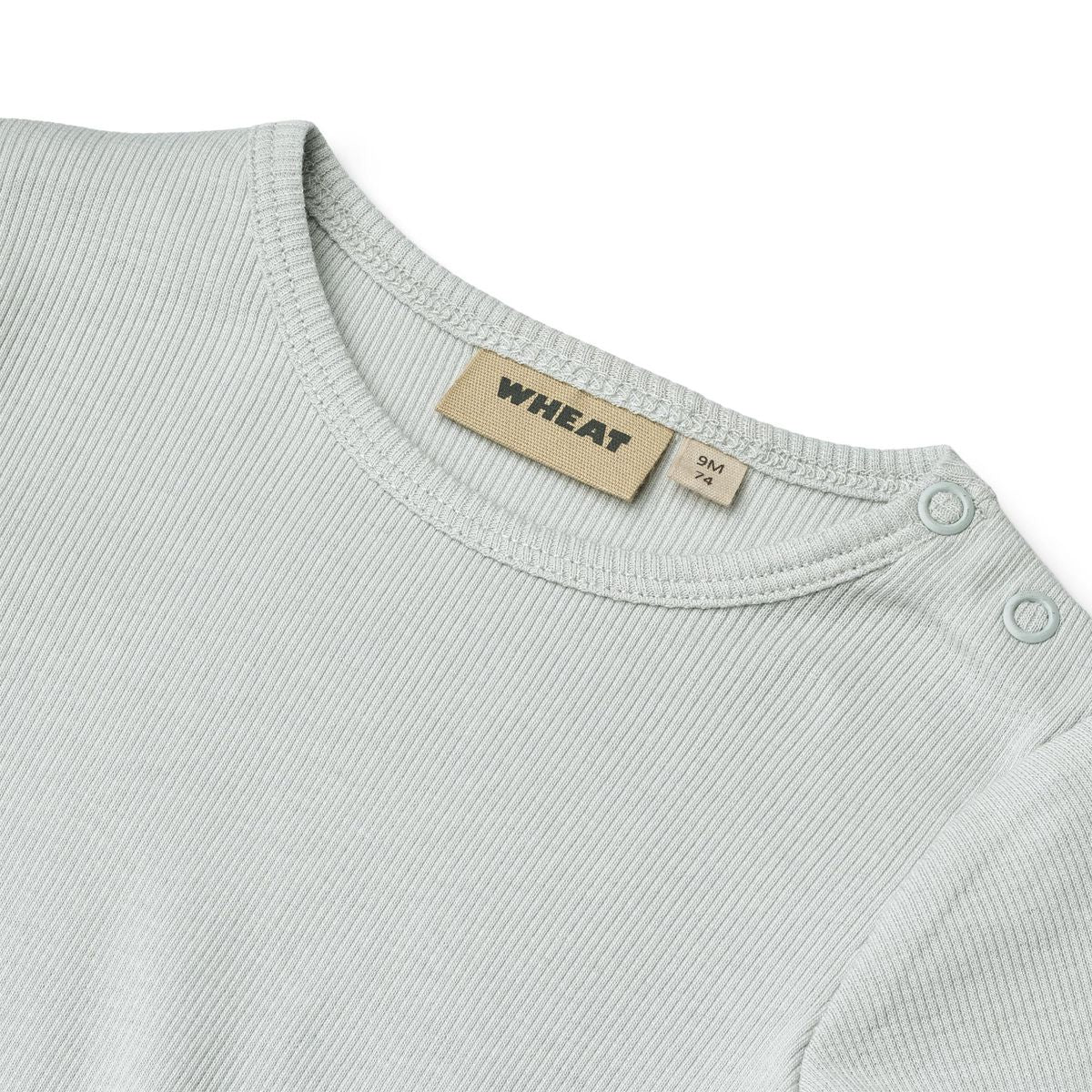 Close up product image of a long sleeve baby bodysuit