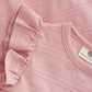Close up product image of a soft pink baby dress