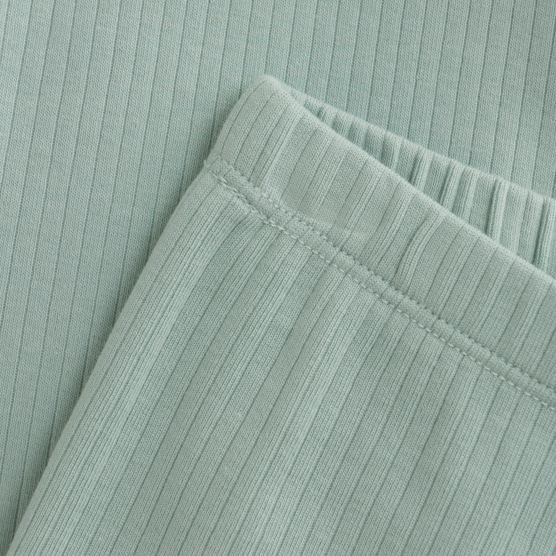 Close up product image of light green baby leggings