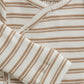Close up product image of a long sleeve wrap front baby bodysuit