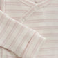 Close up product image of a long sleeve wrap front baby bodysuit