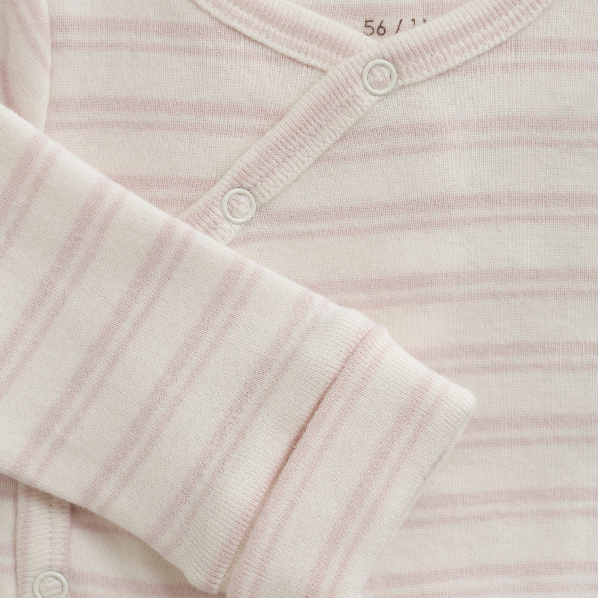 Close up product image of a long sleeve wrap front baby bodysuit