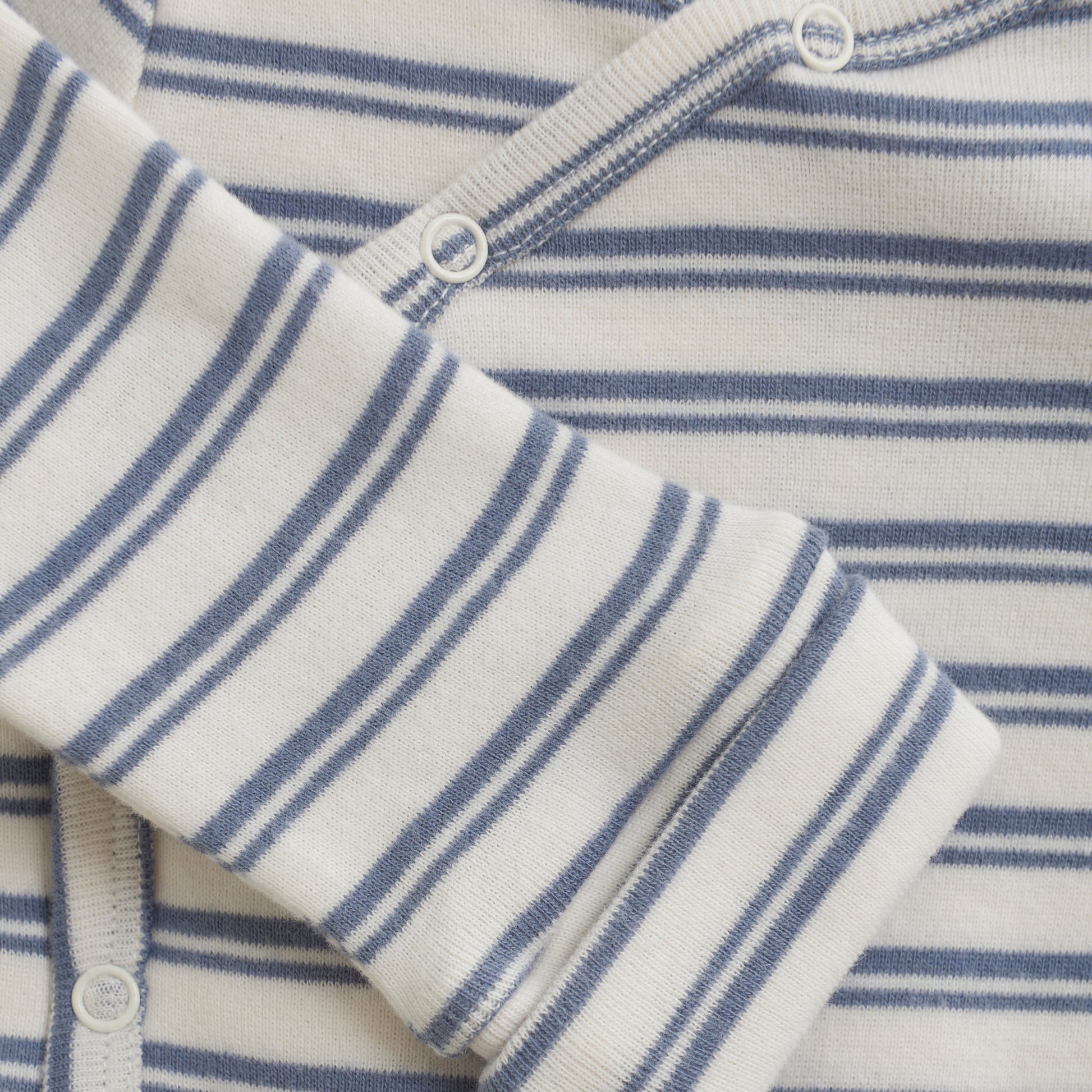 Close up product image of a long sleeve wrap front baby bodysuit