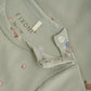 Close up product image of a short sleeve tee with a green desert print