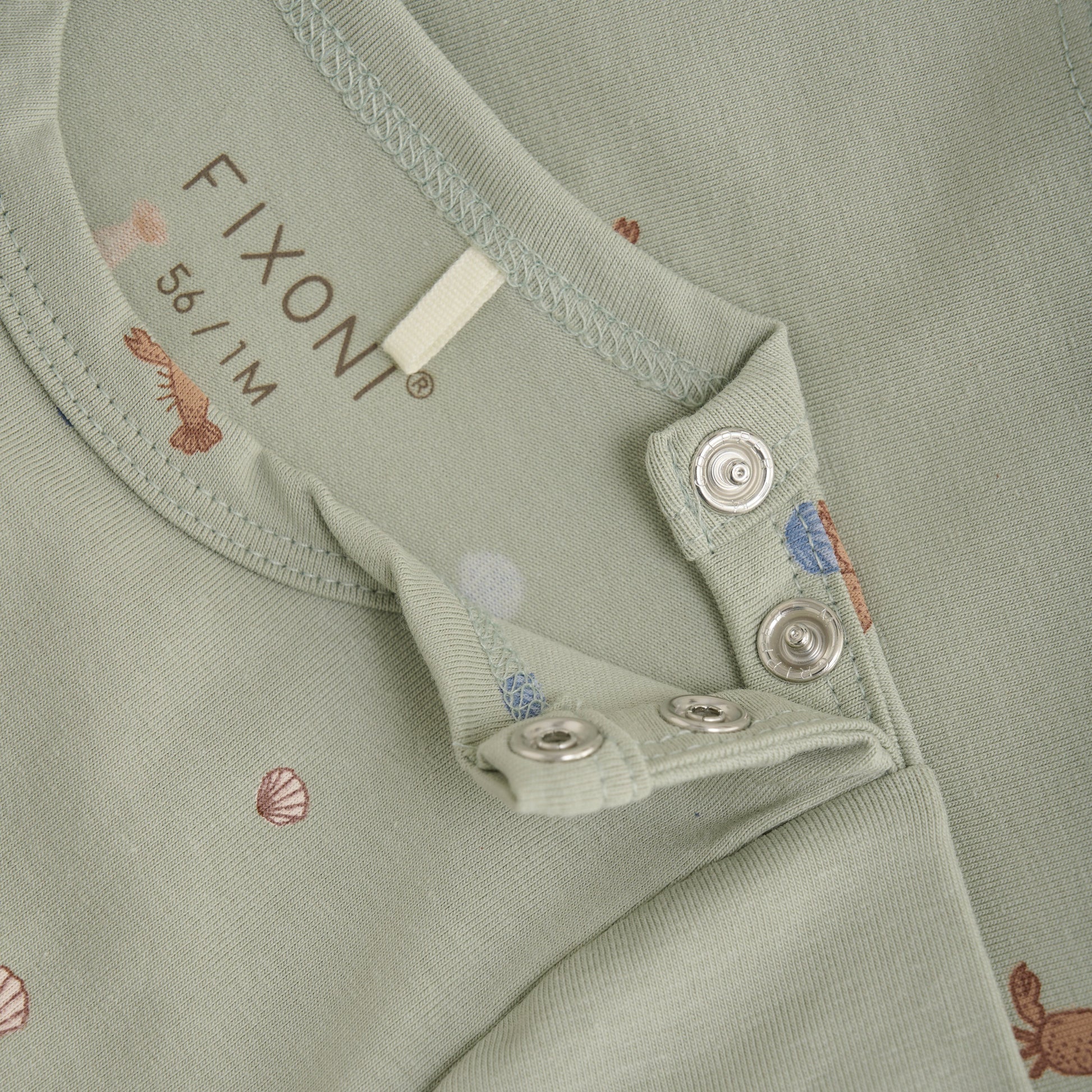 Close up product image of a short sleeve tee with a green desert print