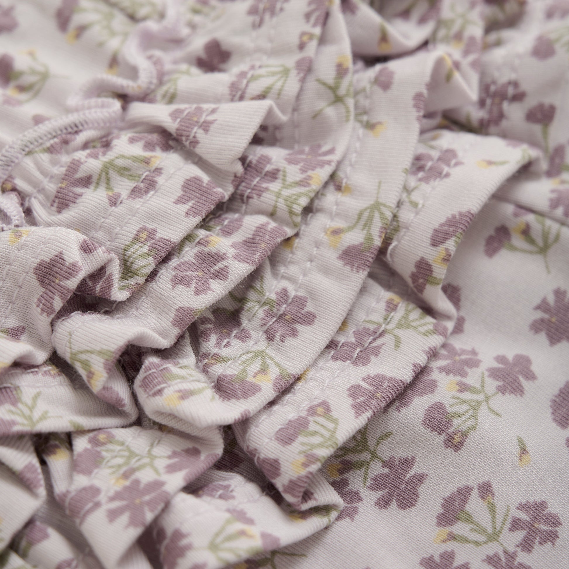 Close up product image of baby leggings in a light lilac floral print