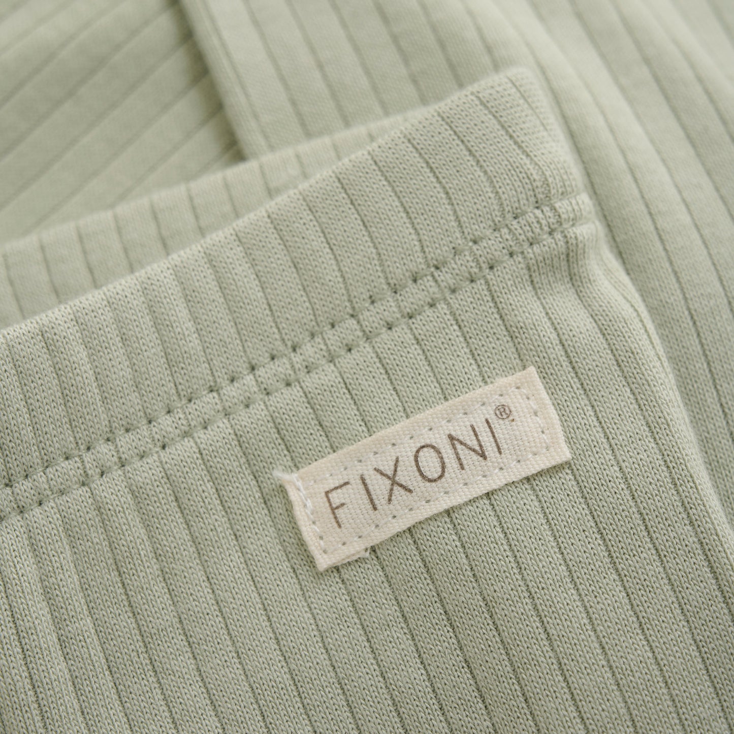 Close up product image of baby leggings in soft green