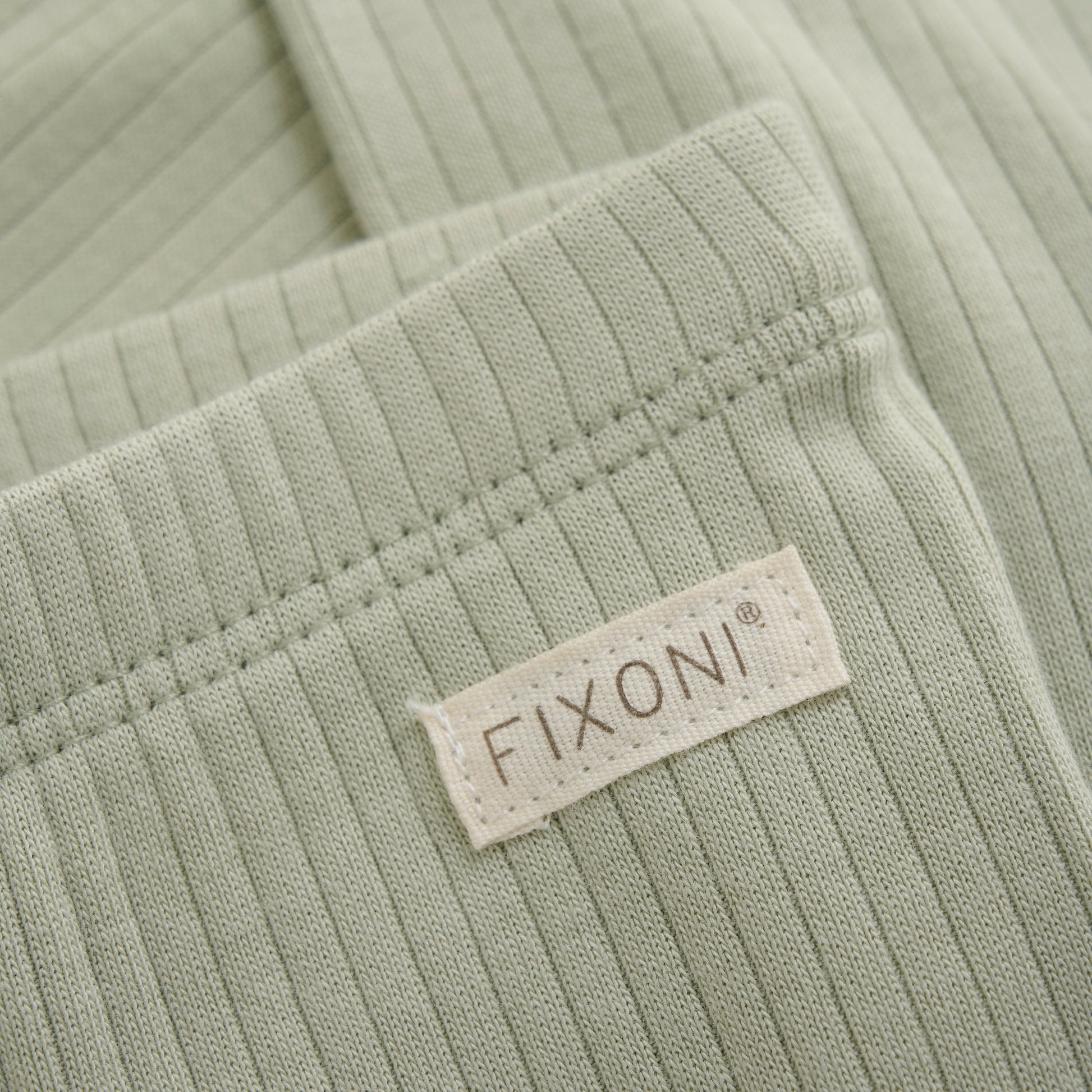 Close up product image of baby leggings in soft green