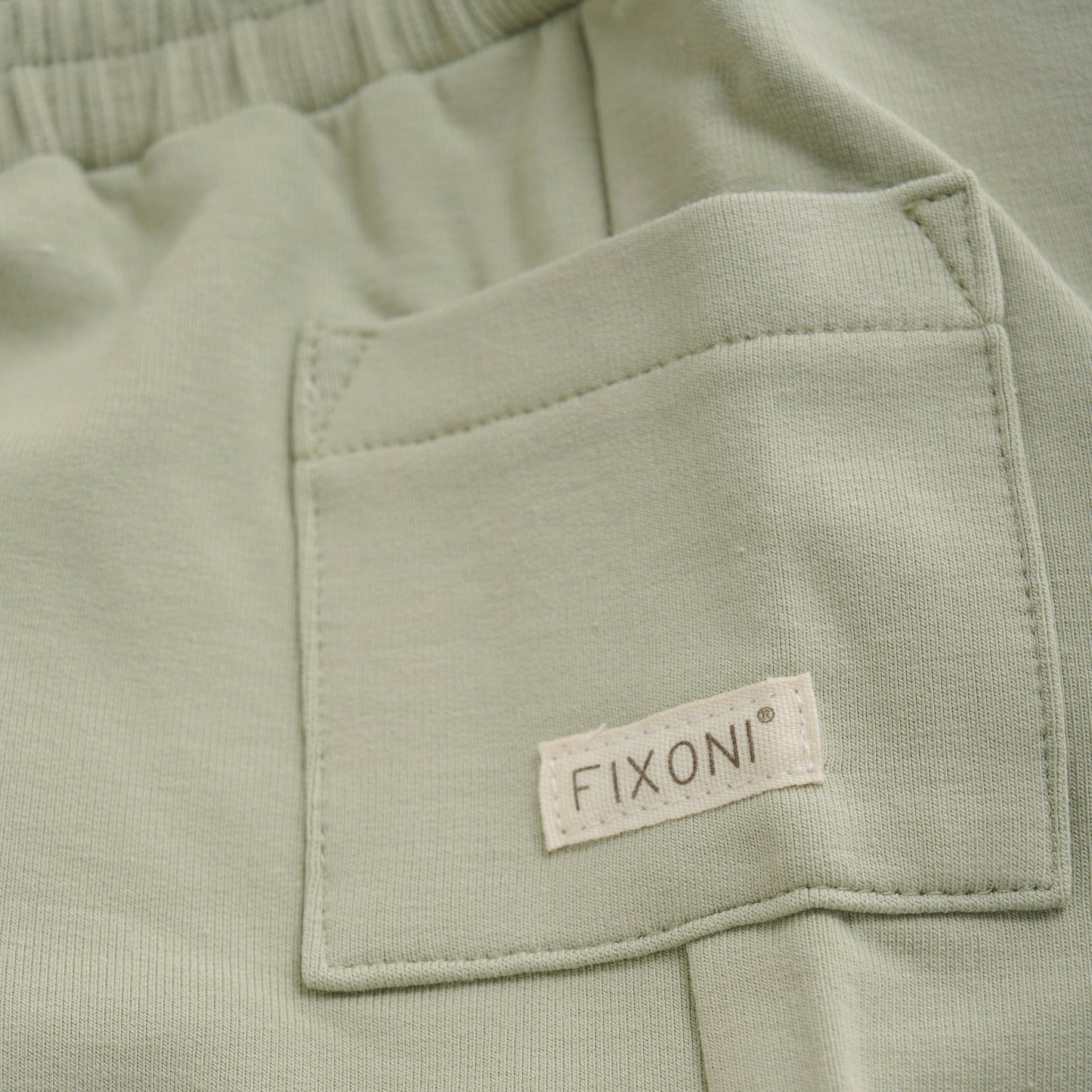Close up product image of light green baby sweat shorts