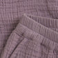 Close up product image of woven baby trousers in purple