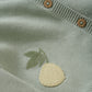 Close up product image of a soft green knit baby cardigan with small pineapple embroidery