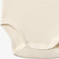 Close up product image of ivory sleeveless baby bodysuit