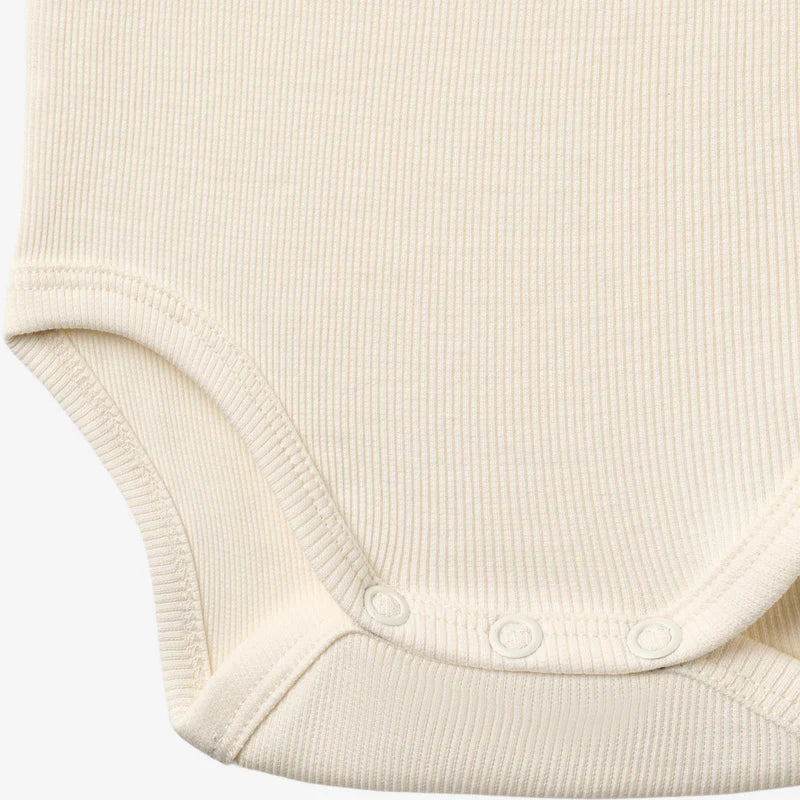 Close up product image of ivory sleeveless baby bodysuit