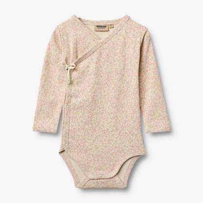 Flat front product image of floral baby wrap bodysuit