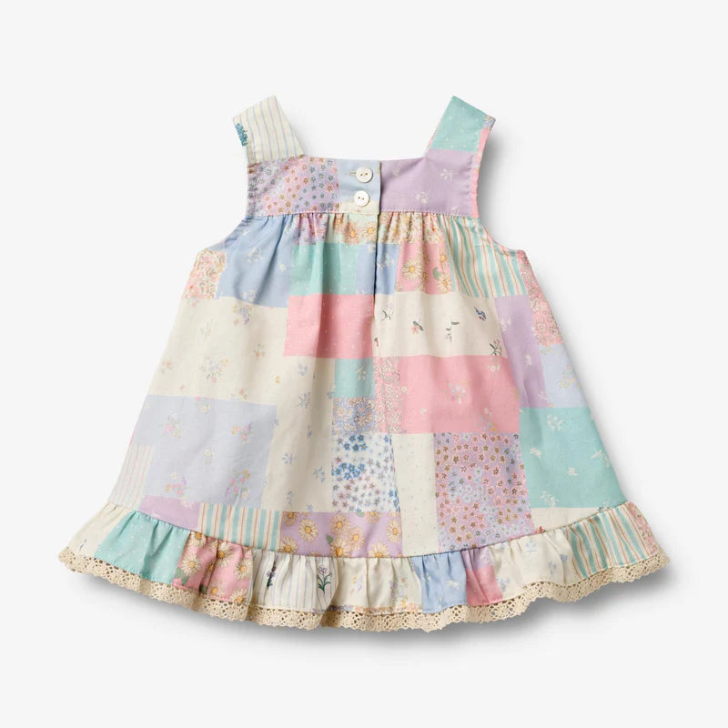 Flat back product image of patchwork baby dress with ruffles