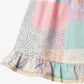 Close up product image of patchwork baby dress with ruffles