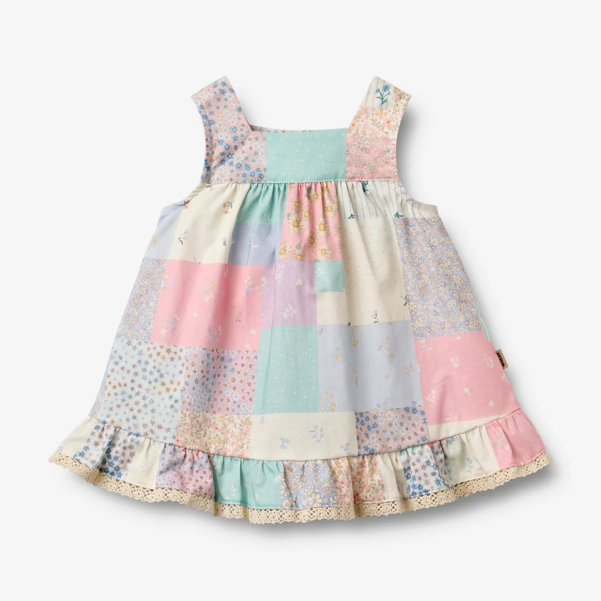 Flat front product image of patchwork baby dress with ruffles
