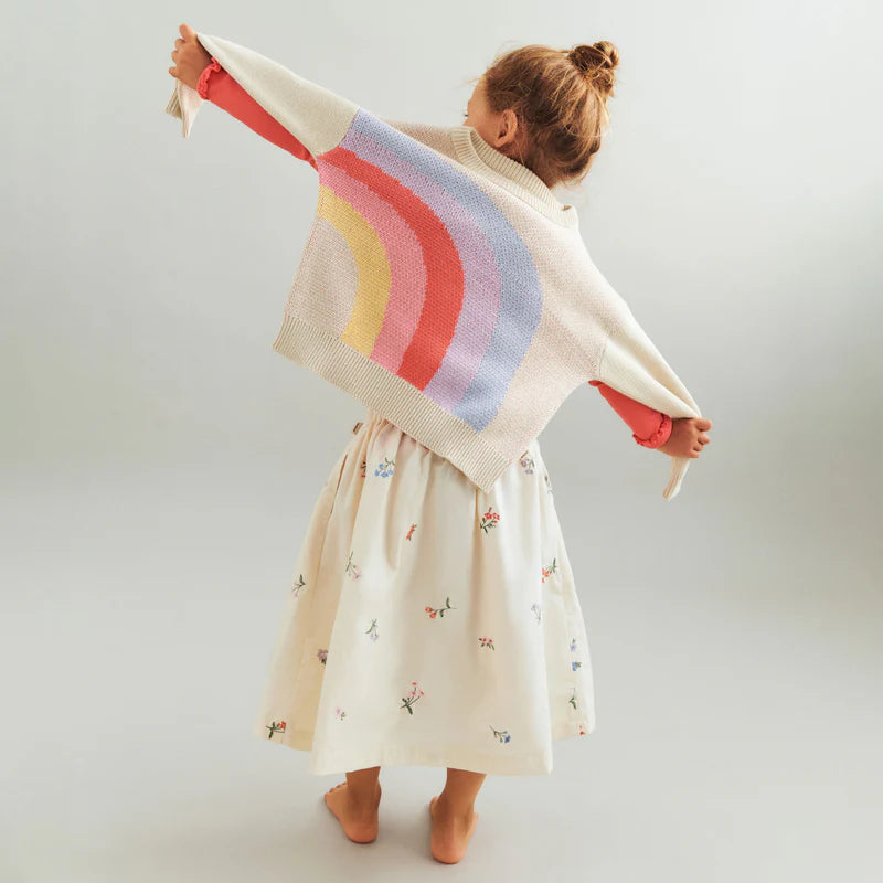 Lifestyle product image of baby laying down wearing a pale peach wrap romper
