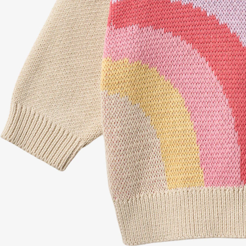Close up product image of knit baby sweater with rainbow print