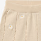 Close up product image of  pale yellow knit baby shorts