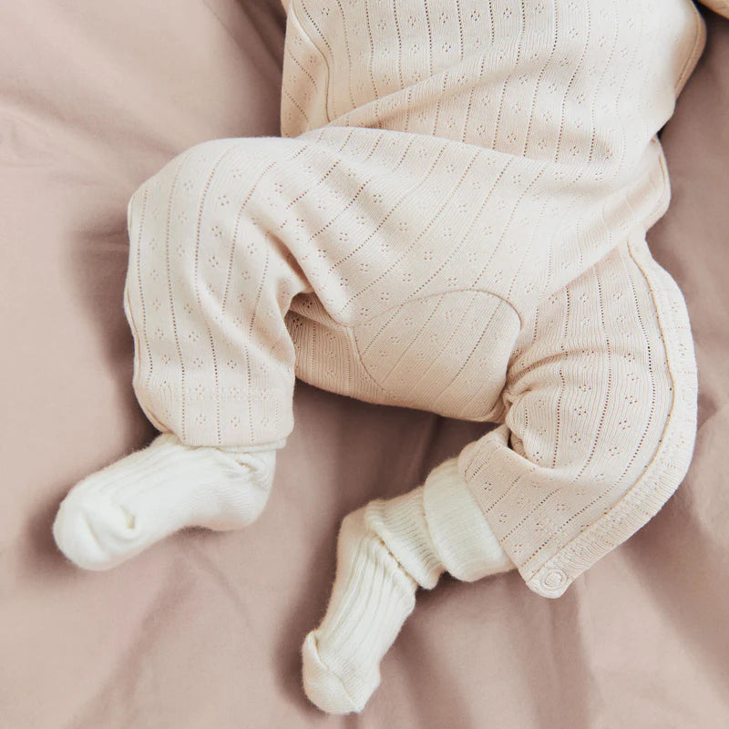 Lifestyle product image of a closeup on a pile of childrens sweaters