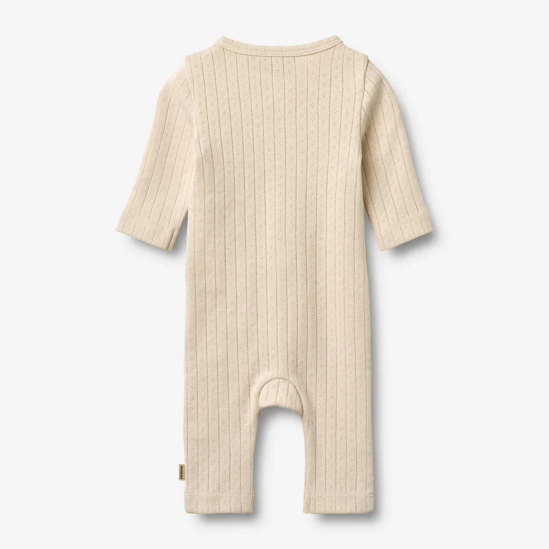 Flat back product image of pale peach baby wrap romper