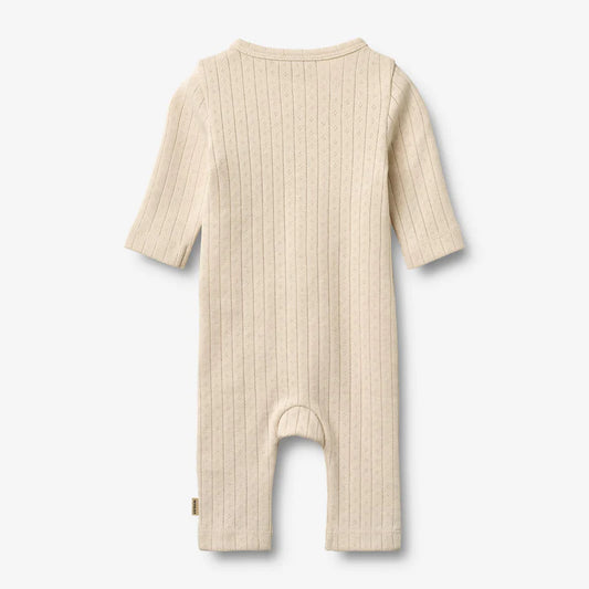 Flat back product image of pale peach baby wrap romper