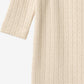 Close up product image of pale peach baby wrap romper