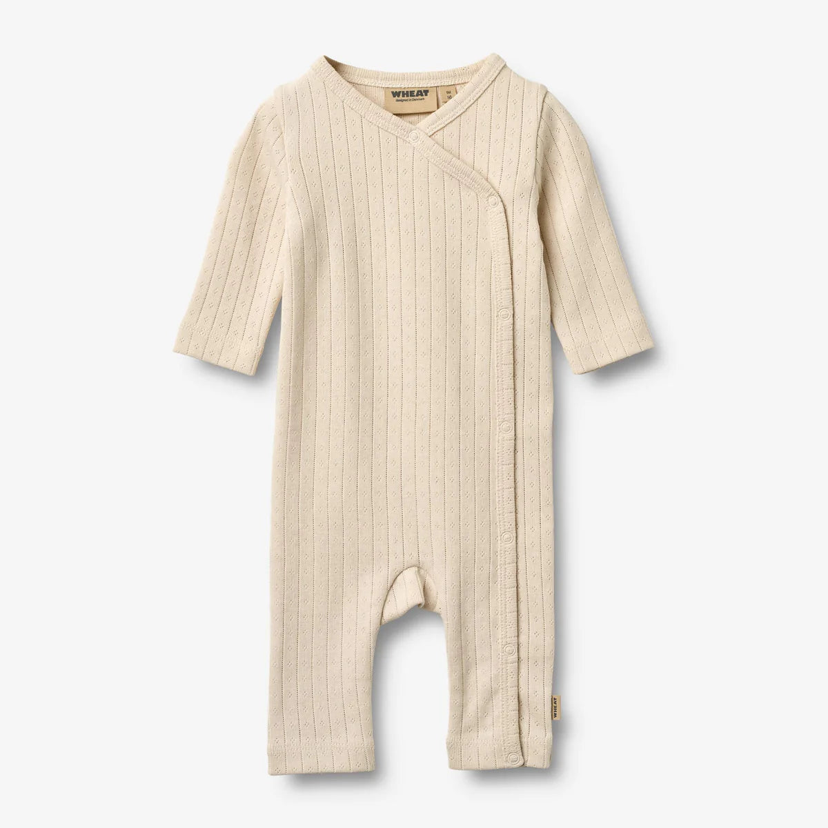 Flat front product image of pale peach baby wrap romper