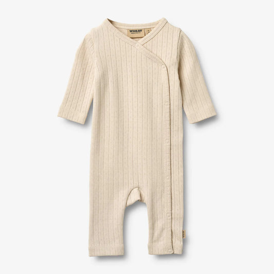 Flat front product image of pale peach baby wrap romper