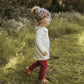 toddler walking outside in a pair of pomegranate leggings and sweatshirt