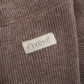 Close up image showing ribbed texture on warm brown baby leggings
