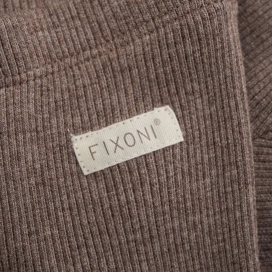 Close up image showing ribbed texture on warm brown baby leggings