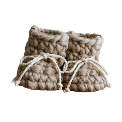 Wool knit baby slippers in a soft sand colour