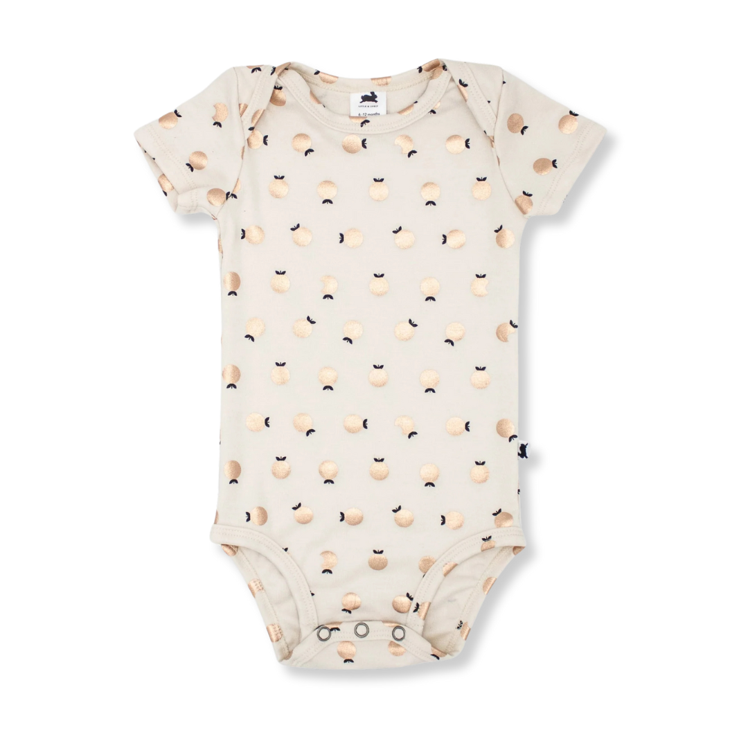 Product image of a short sleeve baby onesie in ivory with a shiny apple all-over print