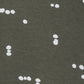 pattern detail of white abstract dots on a dark green background