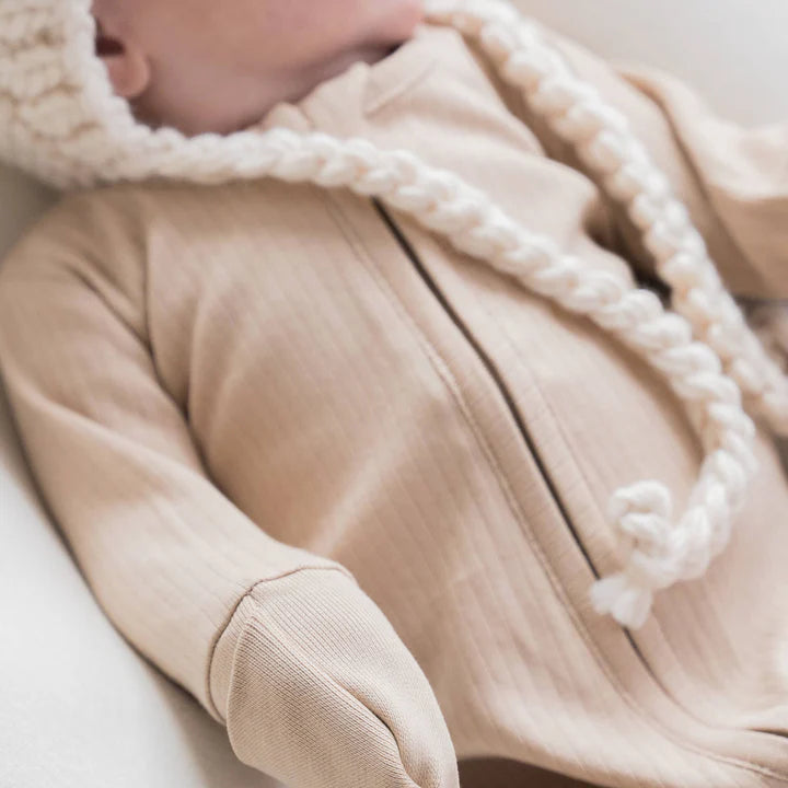 Close up image of the ribbing detail on a baby sleeper with foldover cuff