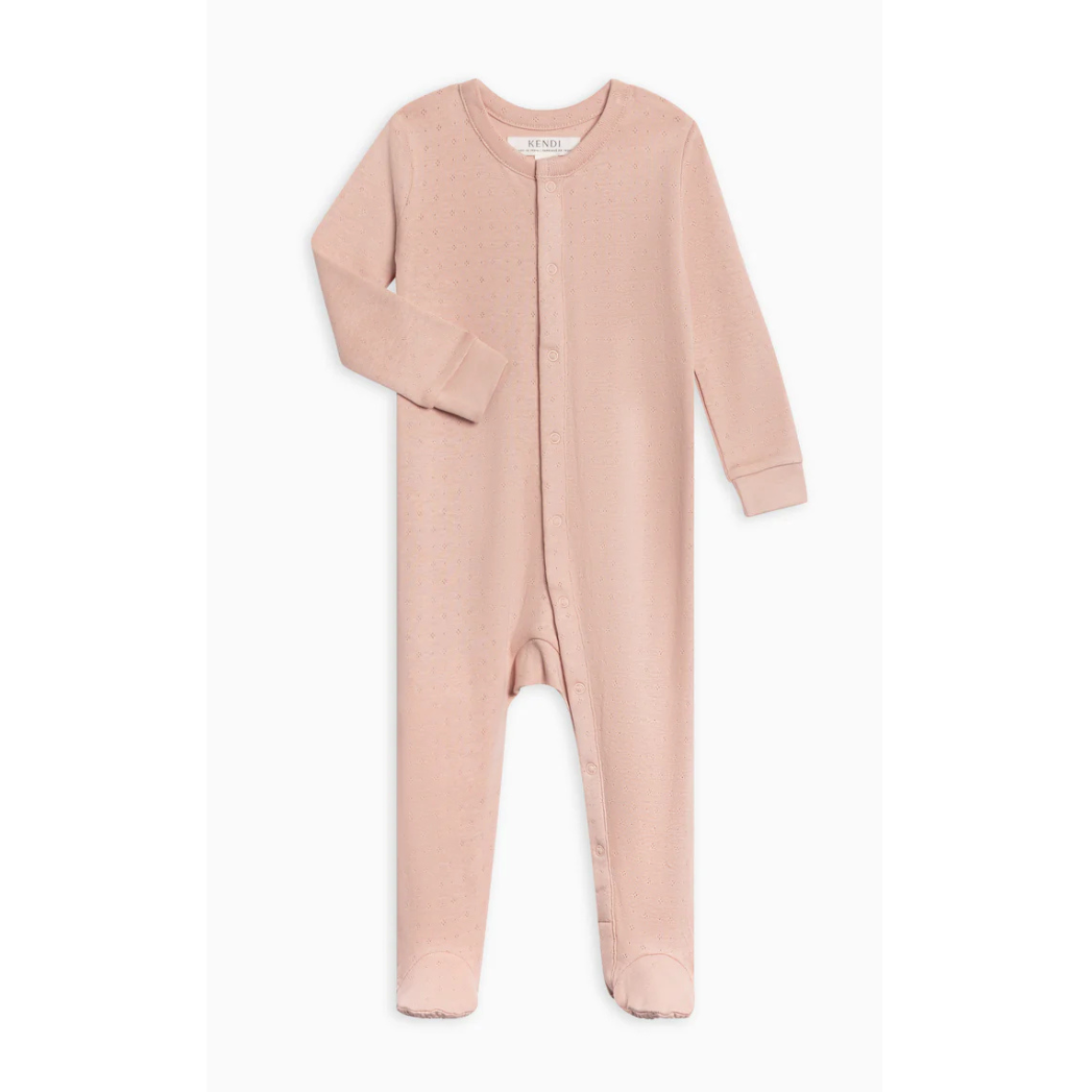 flat lay of a baby footed sleeper in pink