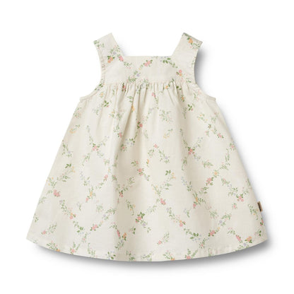 Flat front product image of a woven cotton baby dress