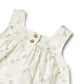 Close up product image of a woven cotton baby dress