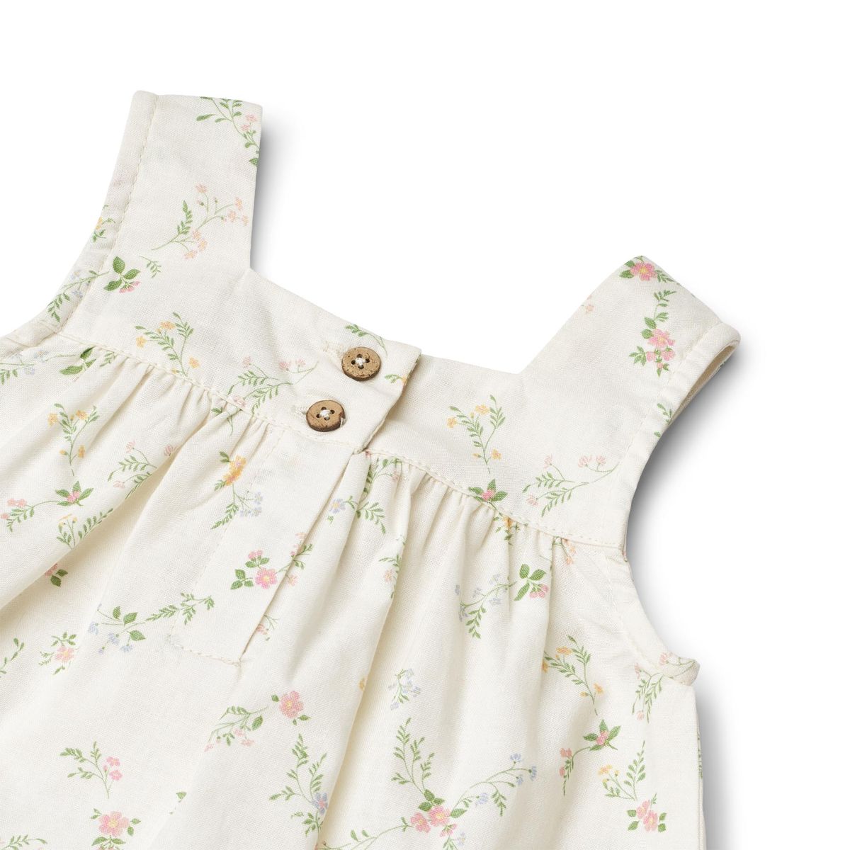 Close up product image of a woven cotton baby dress