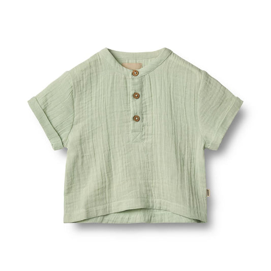 Flat front product image of a woven relaxed fit baby shirt