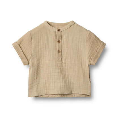 Flat front product image of a woven relaxed fit baby shirt