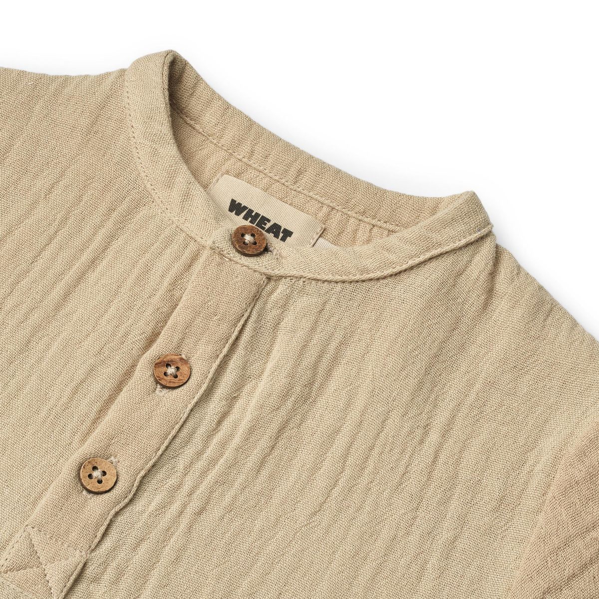Close up product image of a woven relaxed fit baby shirt